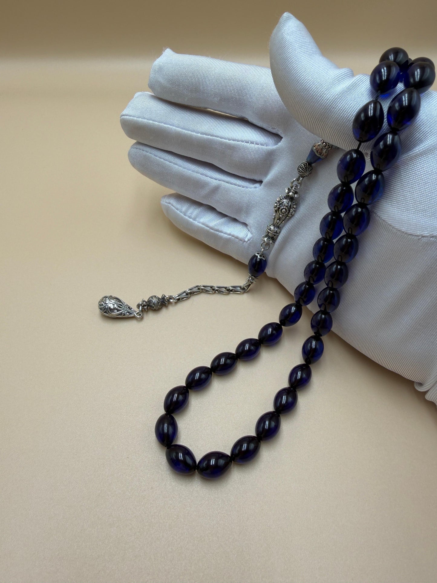 مسباح سندلوس أزرق، مأذنة مشغولة مميّزة. Blue Sandalwood Misbah with a Distinctive Handcrafted Minaret-Style Finial.