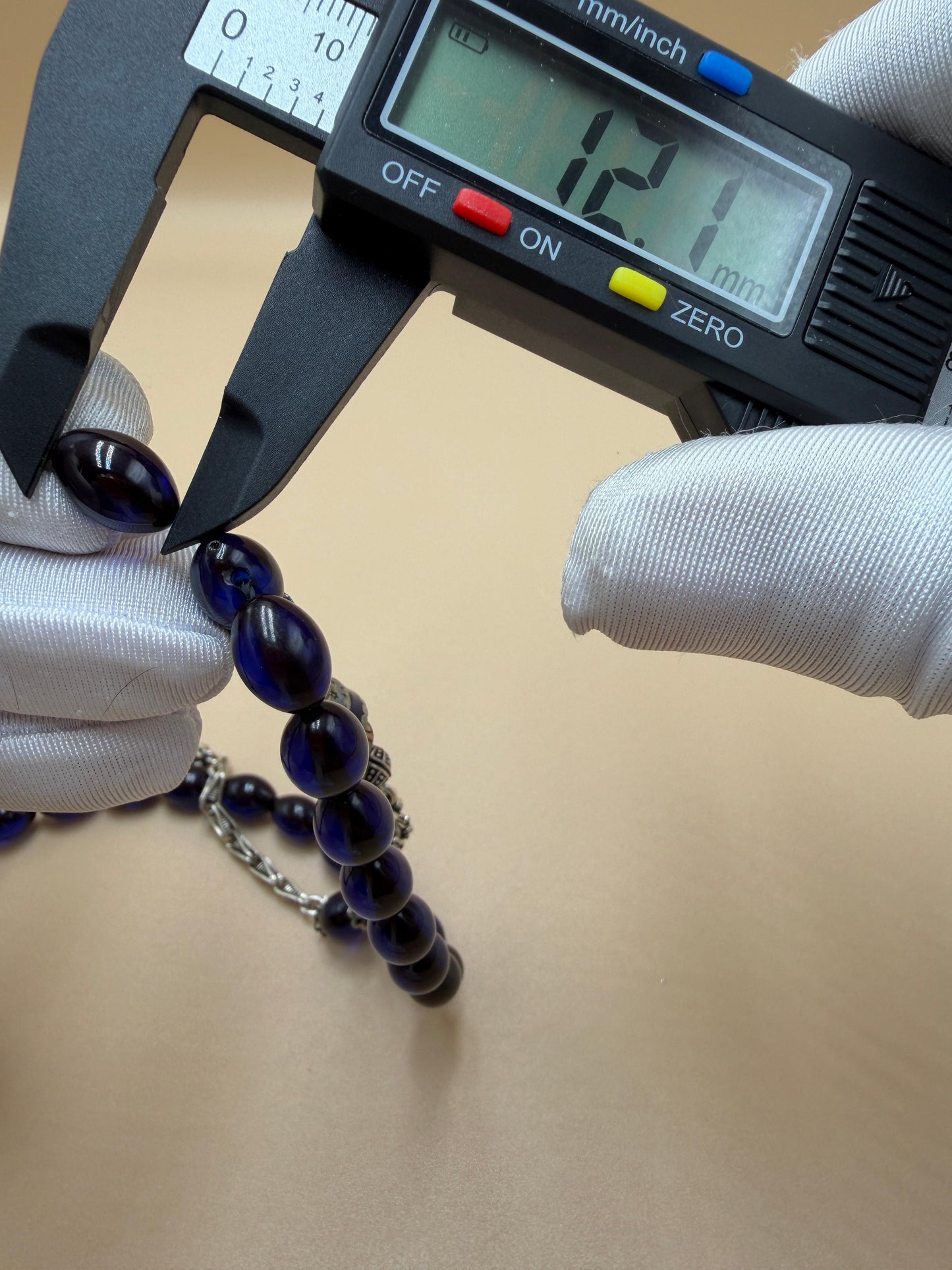 مسباح سندلوس أزرق، مأذنة مشغولة مميّزة. Blue Sandalwood Misbah with a Distinctive Handcrafted Minaret-Style Finial.