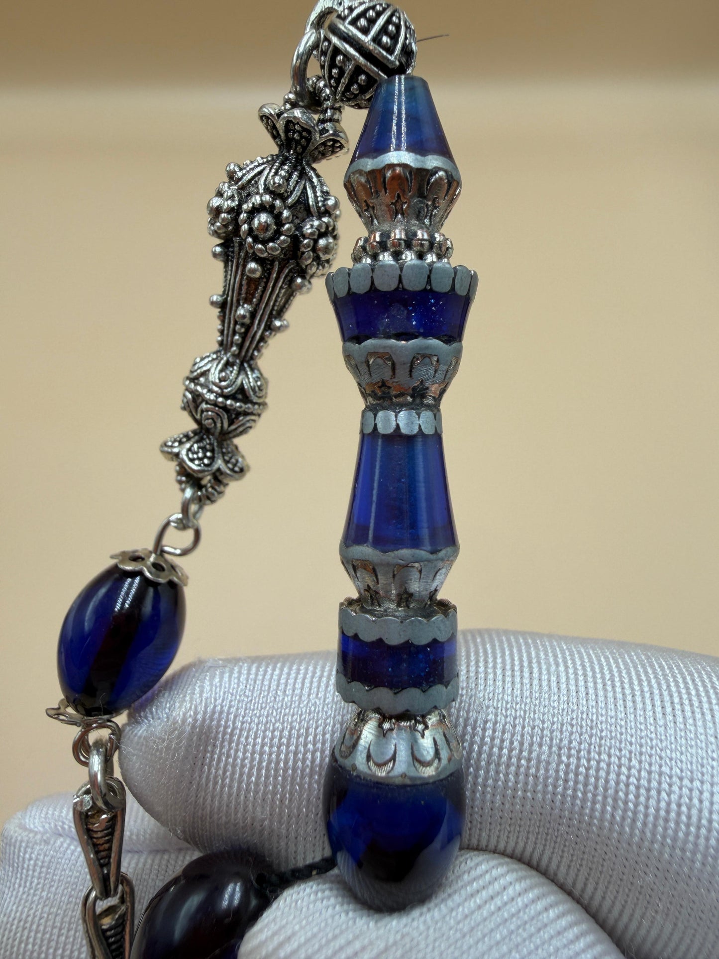 مسباح سندلوس أزرق، مأذنة مشغولة مميّزة. Blue Sandalwood Misbah with a Distinctive Handcrafted Minaret-Style Finial.