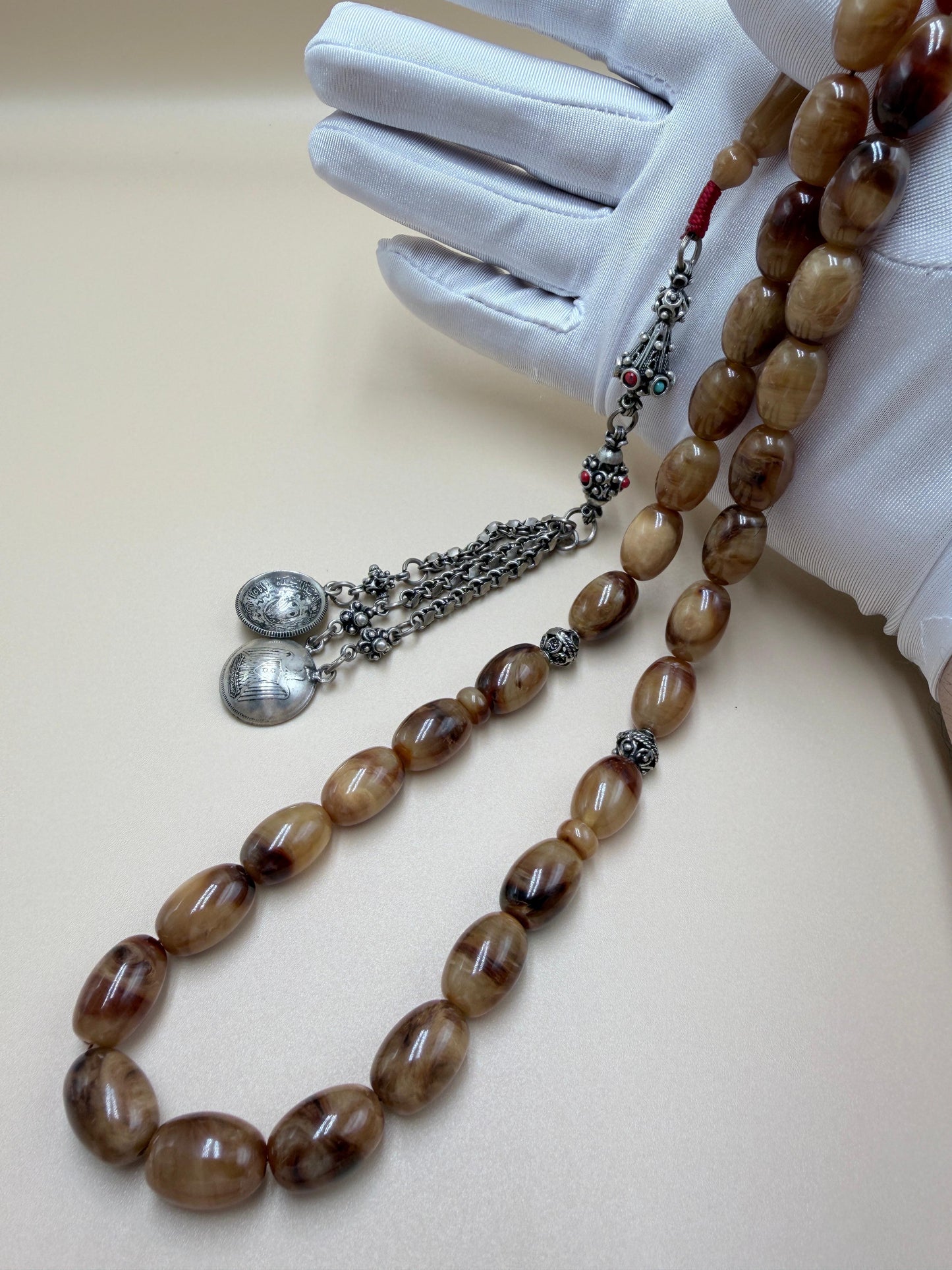 مسباح سندلوس خام عصيان مع شرّابة فضة عيار ٥٠٠. Raw Sandalwood Misbaha with natural stick beads, finished with a 500 silver tassel.