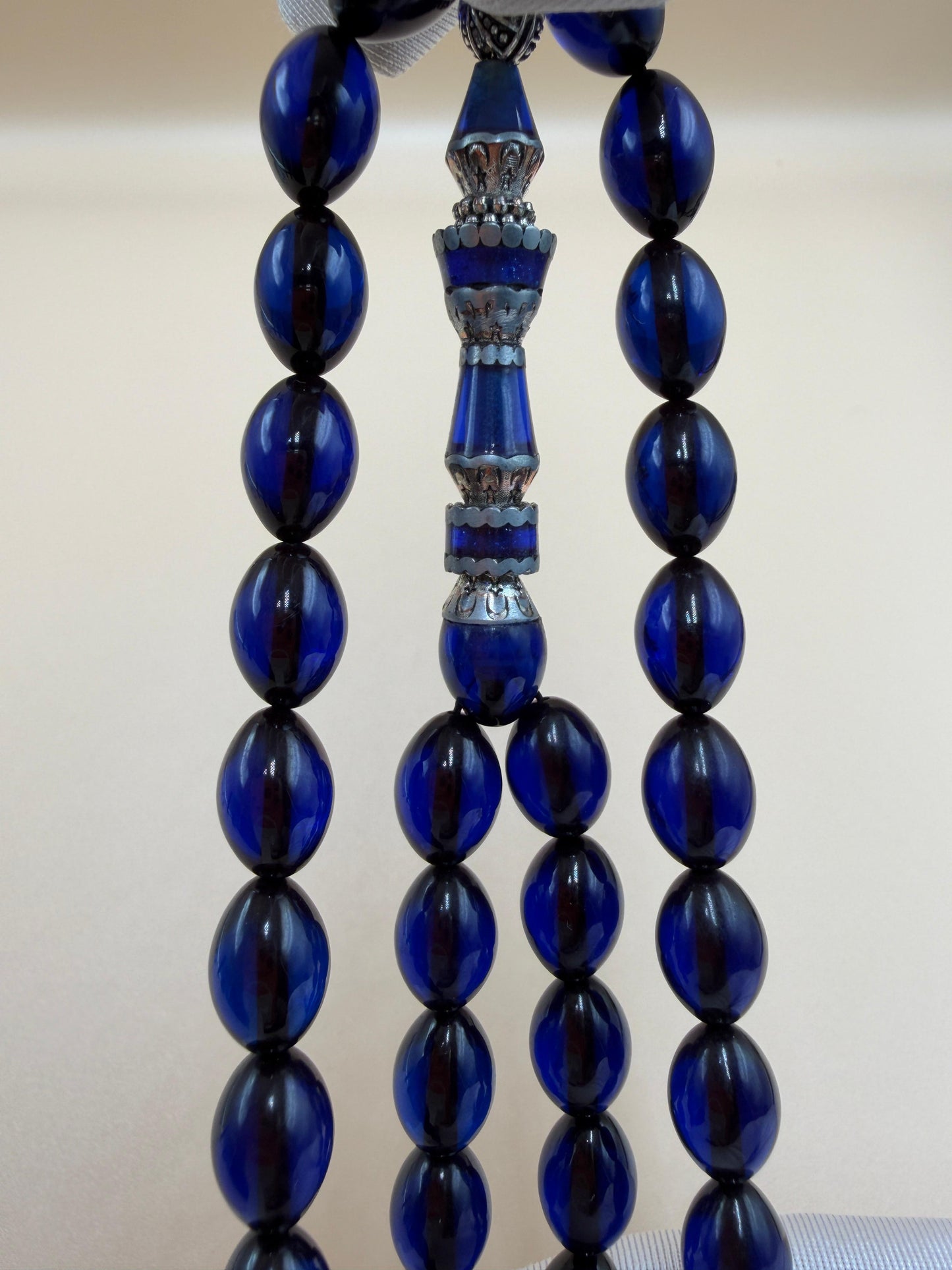 مسباح سندلوس أزرق، مأذنة مشغولة مميّزة. Blue Sandalwood Misbah with a Distinctive Handcrafted Minaret-Style Finial.