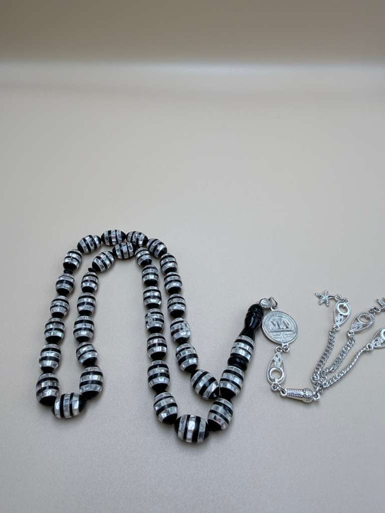 مسباح كوك، مطعّم صدف، خراطة مسباح السواح.
Kuka Wood Misbah, Inlaid with Mother of Pearl, Handcrafted by Al-Sawah Rosary Workshop.