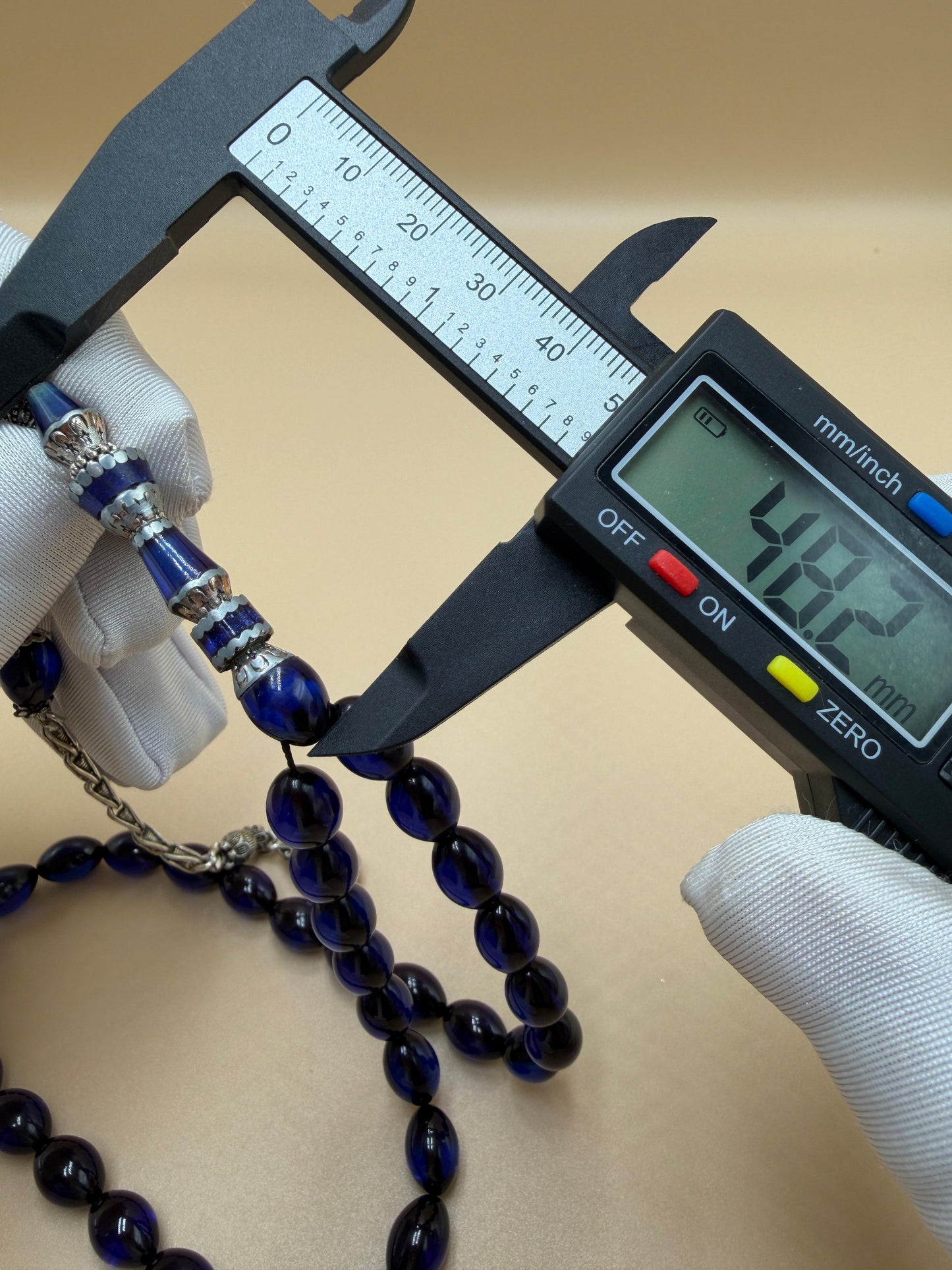 مسباح سندلوس أزرق، مأذنة مشغولة مميّزة. Blue Sandalwood Misbah with a Distinctive Handcrafted Minaret-Style Finial.