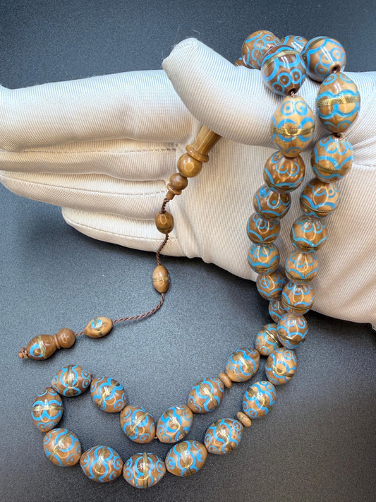 مسباح نارجيل مطعم نحاس ومينا فيروزnarjil cook -wood Misbaha inlaid with copper Coconut-wood Misbaha inlaid with copper and accented with turquoise enamel.