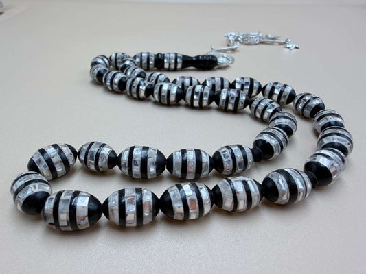 مسباح كوك، مطعّم صدف، خراطة مسباح السواح.
Kuka Wood Misbah, Inlaid with Mother of Pearl, Handcrafted by Al-Sawah Rosary Workshop.