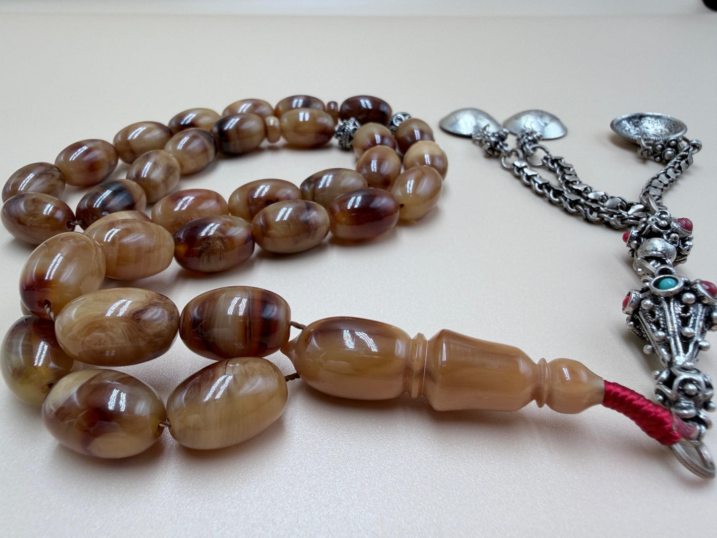 مسباح سندلوس خام عصيان مع شرّابة فضة عيار ٥٠٠. Raw Sandalwood Misbaha with natural stick beads, finished with a 500 silver tassel.